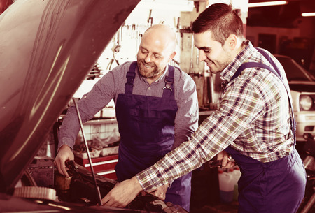 Portrait of two happy professional car mechanics at workshop
の写真素材