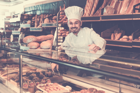 Professional baker is demonstrating assortment of bakery.の写真素材