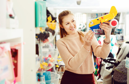 glad consumer with children's plastic toys in the kids storeの写真素材