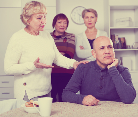 Mature woman is apologizing to friend for quarrel at home.の写真素材