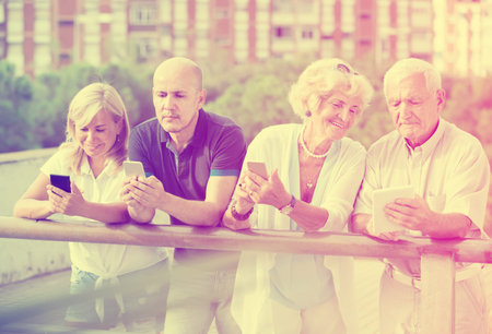 mature people chatting in mobile in the outdoor