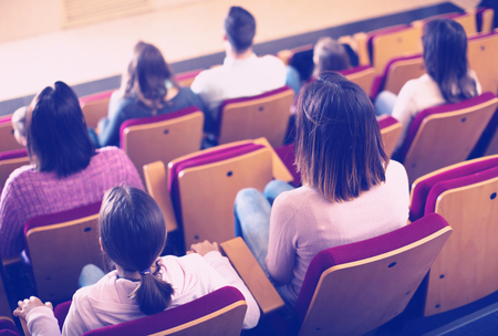 Group of people waiting for beginning of movie in cinemaの写真素材