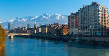 View of Grenoble with gothic spire of Saint-Andre Church against backdrop of snowy Alps in sunny day, France
の写真素材