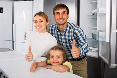 portrait of smiling family shopping in household appliance store  の写真素材