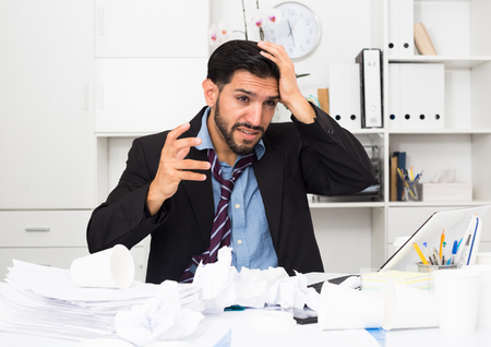 Man employee is indignant because he is having issues with project in office.の写真素材