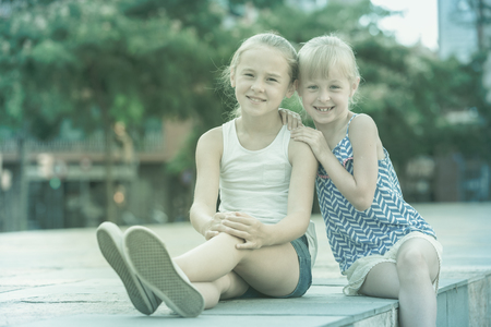 Portrait of two girls playmates outdoors in summer dayの写真素材