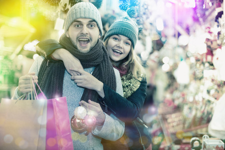 Young couple in hat expression happinnes from buying decoration at Christmas fairの写真素材