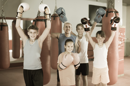 Mixed boxing team of kids loves training with a coach.の写真素材