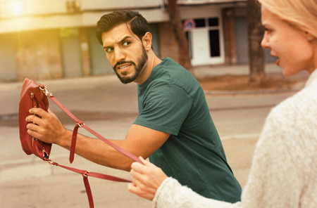 Female is displeased of theft her bag on the street.の写真素材