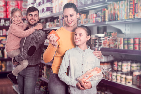 Young family of four shopping together in grocery storeの写真素材