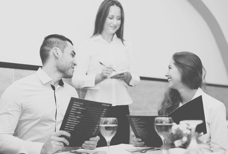 Portrait of happy young couple at the restaurantの写真素材
