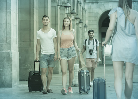 Travelers taking walk in town at summer dayの写真素材