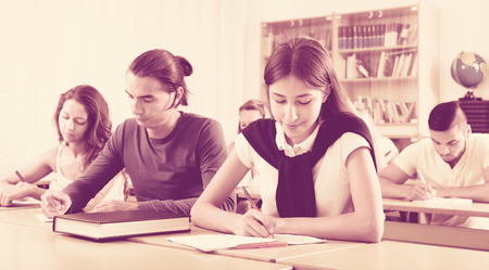 Group of young caucasian students studying in the classroomの写真素材