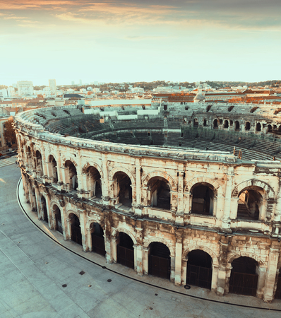 Aerial view of Roman amphitheatre on background with cityscape of Nimes, Franceの写真素材
