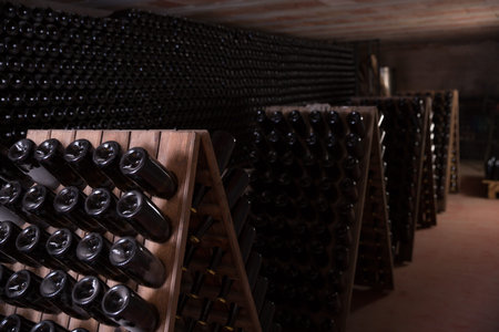 Process of wine maturation in bottles on wooden racks in wine vault