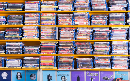 BARCELONA, SPAIN - FEBRUARY 15, 2018: Colored shelves of CD shop with various films and serialsのeditorial素材