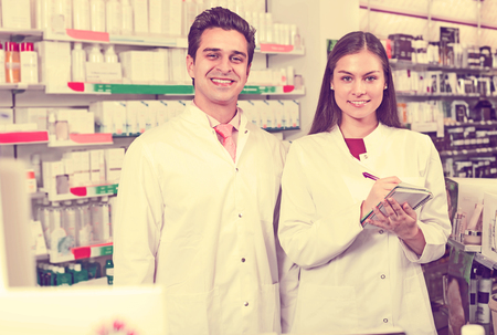 Young team of pharmaceutist and technician working at the chemist shopの写真素材