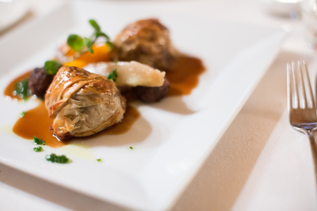 Expensive dish of high cuisine with oxtails and raviolisの写真素材