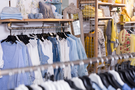 Image of different colored clothes in the modern shopping centreの写真素材
