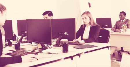 Business people working and communicating together in the modern open plan office