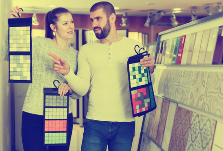 Laughing couple looking sample of  ceramic tile  in shop
の写真素材