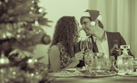 Happy family celebrating Christmas at the tableの写真素材