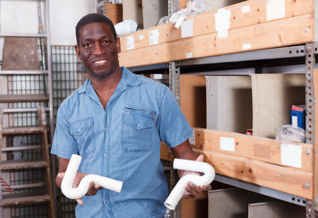Laughing African American looking for construction supplies for renovation works in building hypermarketの写真素材