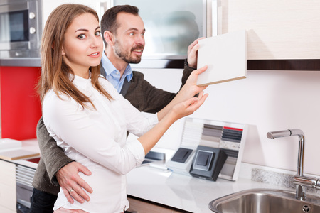Married couple looking for stylish materials for kitchen furnishing in store
の写真素材