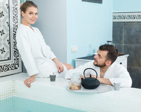 Loving couple drinking tea during wellness weekend in spa center