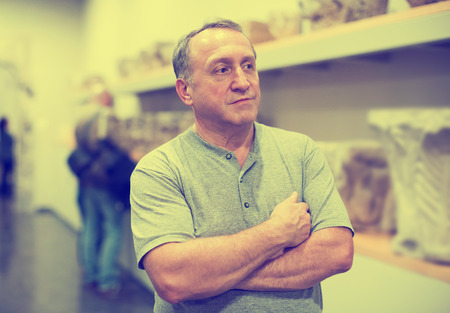 Adult man is visiting at the exposition in historical museumの写真素材