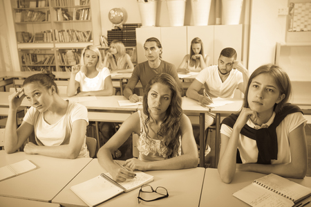 Group of adult european students studying together in classroomの写真素材