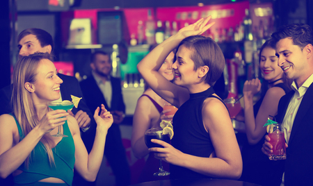 Colleagues dancing on corporate party with cocktails in handsの写真素材