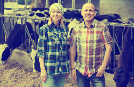 Professional farm workers  posing near cowhouse in modern farm
の写真素材