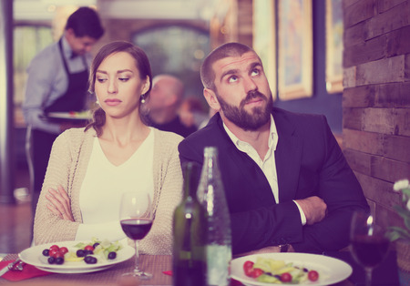 quarreled visitors young couple in restaurant on celebrateの写真素材