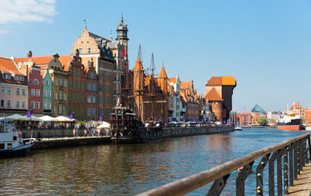 Motlawa river embankment in old Polish town of Gdansk with moored wooden pleasure craft in sunny day