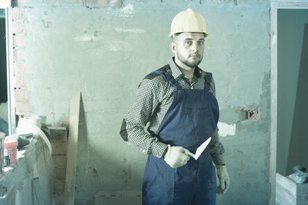 Diligent  professional plasterer is ready to plaster the walls at the object.の写真素材