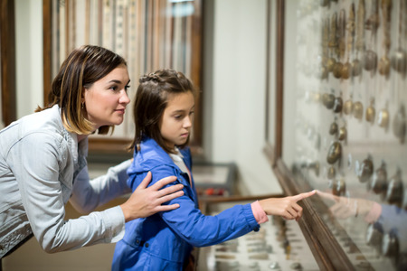 Glad mother and daughter exploring medieval expositions in museumの写真素材