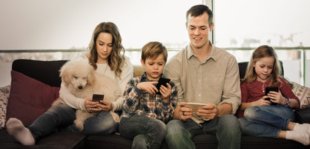Youn family playing with their smartphones together at home