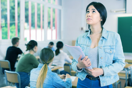 Portrait of unhappy schoolgirl who is dissatisfied assessment in the class