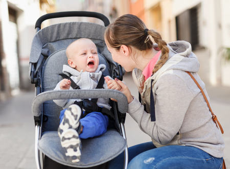 Young female mother with her child shopping and walkingの写真素材