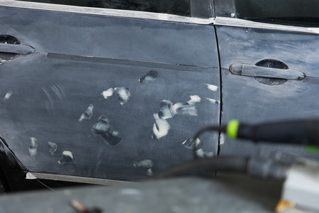 View of car prepared for painting in professional auto workshopの写真素材