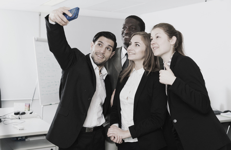 Happy group of business people making selfie in modern officeの写真素材