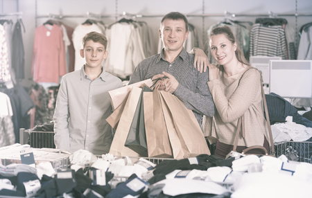 Portrait of two generations showing shopping bags with purchase in the shop Portrait of two generations showing shopping bags with purchase in the shop