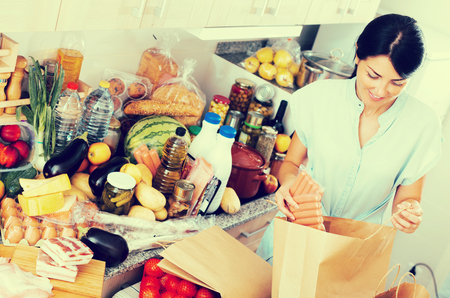 Female is posing in time cooking on the kitchen at home.の写真素材
