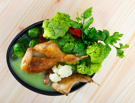 Cream soup boiled with quail, served with  broccoli,  brussels sprouts and cauliflowerの写真素材