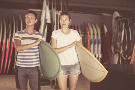 Young couple is ready for surfing with surfboard in summerの写真素材
