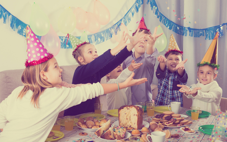 Boys and girls happy to celebrate friendâs birthday during dinnerの写真素材