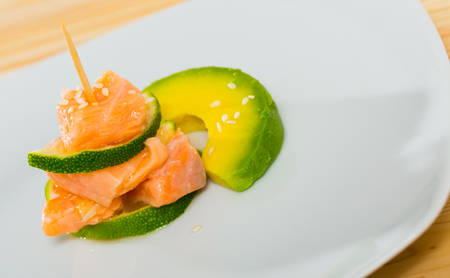 Refreshing salmon ceviche with lime and slices of ripe avocadoの写真素材