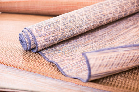 Image of wattled organic bamboo rugs at interior shop, no people
