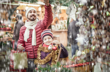 Man with daughter choosing decorations for Xmasの写真素材